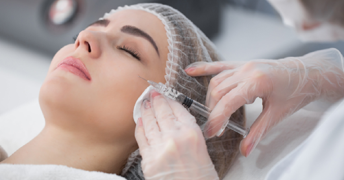 Young woman with eyes closed receiving a Natural Growth Factor injections from a medical professional in Foxborough, MA